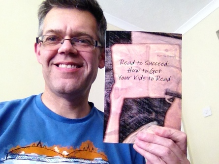 Martin holding his new book 'Read to Succeed: How to Get Your Kids to Read'